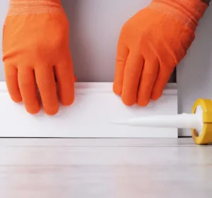 Installation,Of,Duropolymer,Skirting,Boards,,Master,Gluing,Floor,Plinth,To